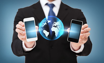 Image showing businessman showing smartphones