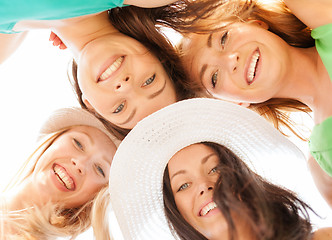 Image showing faces of girls looking down and smiling