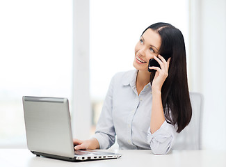 Image showing businesswoman with laptop and cell phone