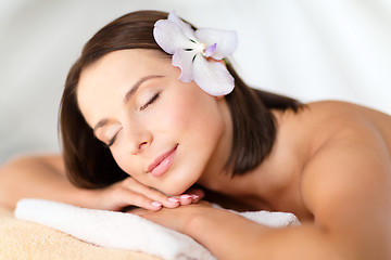 Image showing beautiful woman with flower in her hair in spa