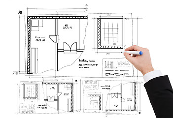 Image showing closeup of businessman hand drawing blueprint