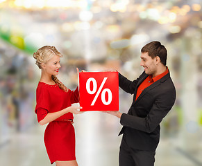 Image showing smiling woman and man with red percent sale sign