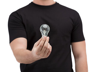 Image showing close up of man holding light bulb