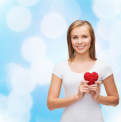 Image showing smiling woman in white t-shirt with heart