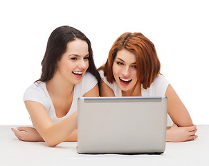 Image showing two smiling teenage girsl with laptop computer