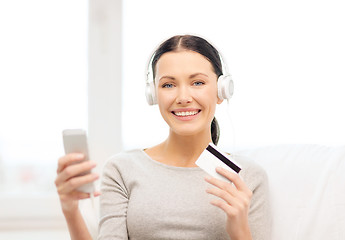 Image showing woman with smartphone and headphones at home