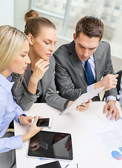 Image showing business team with tablet pc having discussion