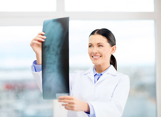 Image showing smiling young doctor in cabinet