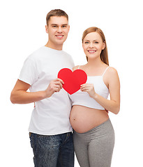 Image showing happy young family expecting child with big heart