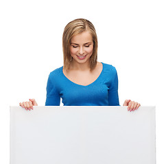 Image showing smiling girl lkooking at blank white board