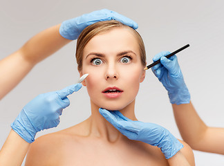 Image showing woman face and beautician hands with pencil