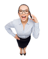 Image showing happy businesswoman in eyeglasses with smartphone