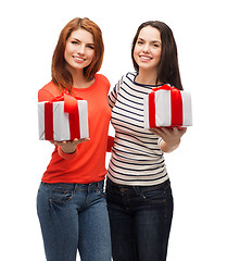 Image showing two smiling teenage girls with presents