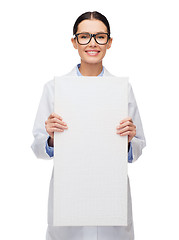 Image showing female doctor in eyeglasses with white blank board