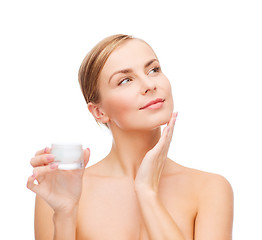 Image showing woman applying cream on her skin