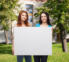 Image showing two smiling young girls with blank white board