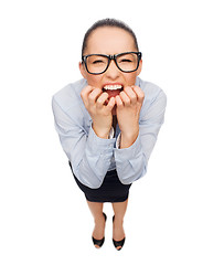 Image showing frightened businesswoman biting her fingers