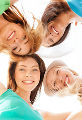 Image showing faces of girls looking down and smiling