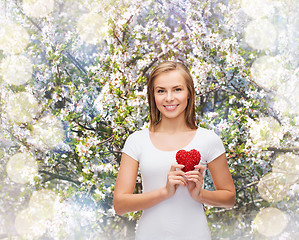 Image showing smiling woman in white t-shirt with heart