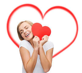 Image showing smiling woman in white t-shirt with heart