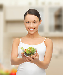 Image showing healthy woman holding bowl with salad in kitchen