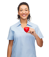 Image showing smiling female doctor or nurse with heart