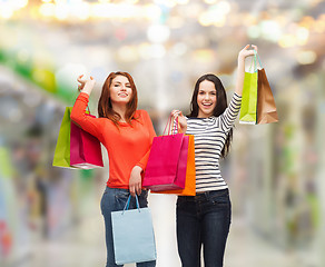 Image showing two smiling teenage girls with shopping bags