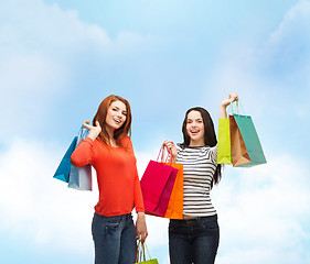 Image showing two smiling teenage girls with shopping bags