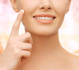 Image showing beautiful woman applying moisturizing cream