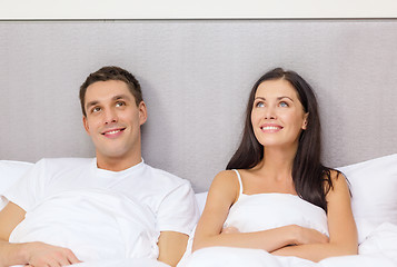 Image showing happy couple dreaming in bed