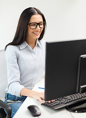 Image showing smiling businesswoman or student with eyeglasses