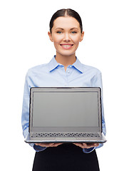 Image showing smiling businesswoman with laptop blank screen