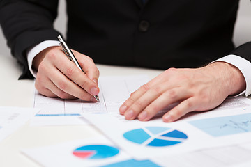 Image showing close up of businessman with papers