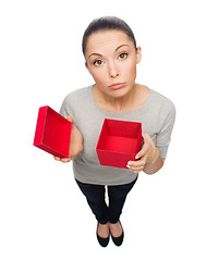 Image showing disappointed asian woman with empty red gift box