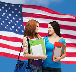 Image showing two smiling students with bag and folders