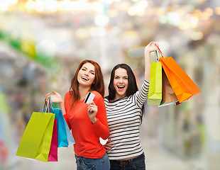 Image showing teenage girls with shopping bags and credit card