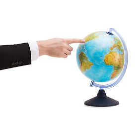 Image showing businessman pointing finger to earth globe