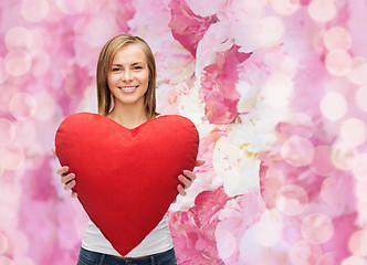 Image showing smiling woman in white t-shirt with heart