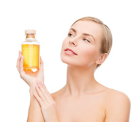 Image showing lovely woman with oil bottle