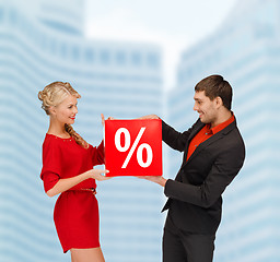 Image showing smiling woman and man with red percent sale sign