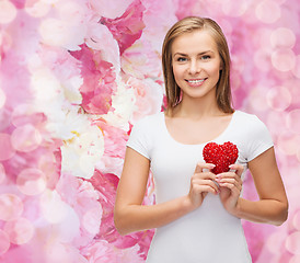 Image showing smiling woman in white t-shirt with heart