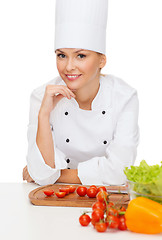 Image showing smiling female chef with vagetables