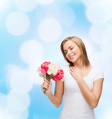 Image showing smiling woman with bouquet of flowers