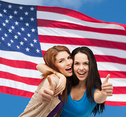 Image showing two smiling girls showing thumbs up