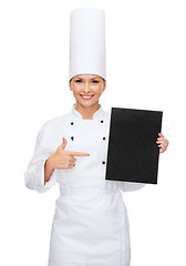 Image showing smiling female chef with black blank paper