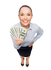 Image showing smiling businesswoman with dollar cash money