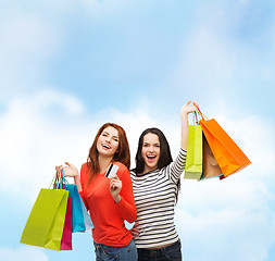 Image showing teenage girls with shopping bags and credit card