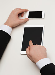 Image showing businessman working with tablet pc and smartphone