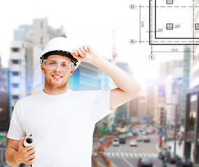 Image showing male architect in helmet with blueprint