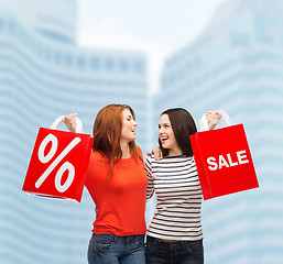 Image showing two smiling teenage girl with shopping bags